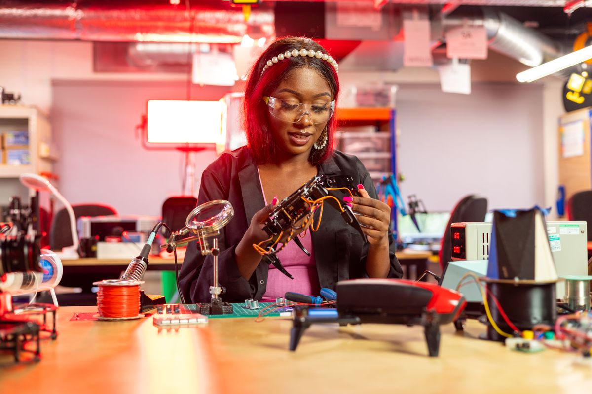 Young engineer working on drone electronics at a soldering bench