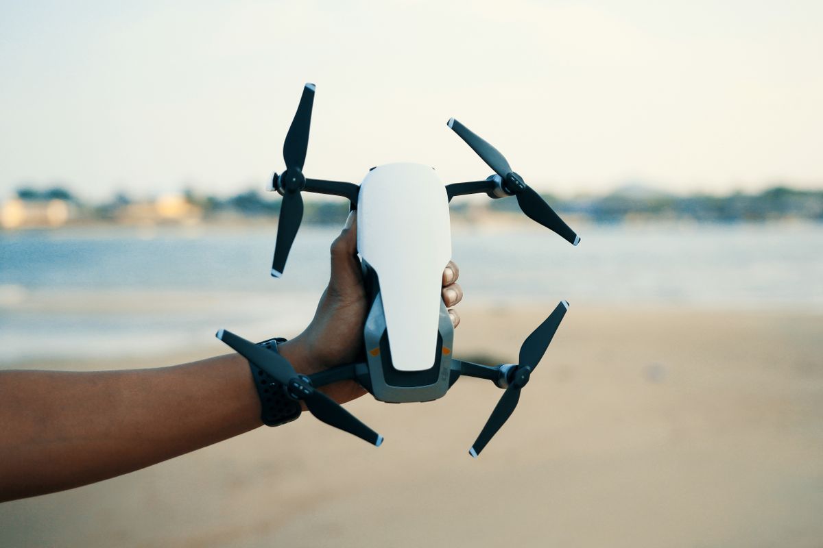 Quadcopter drone held ready for an outdoor flight session